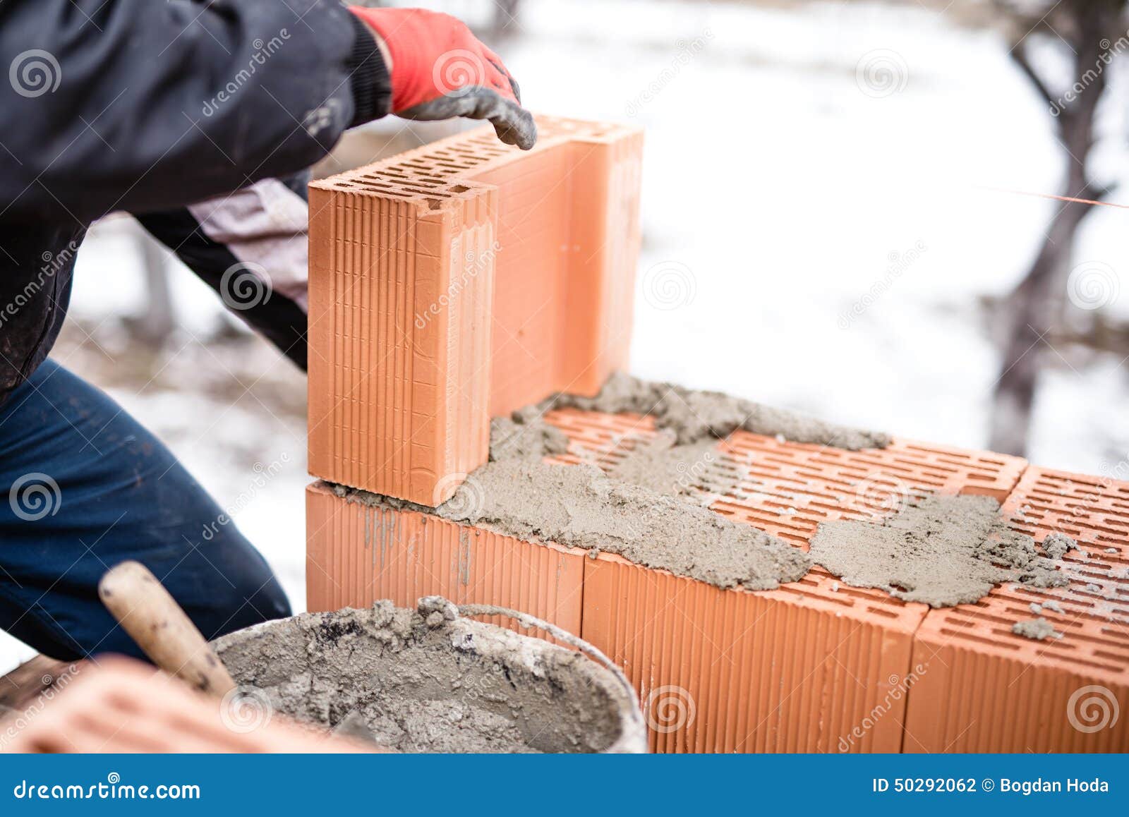 Worker Buliding Brick Walls at House Construction Site, Bricklayer