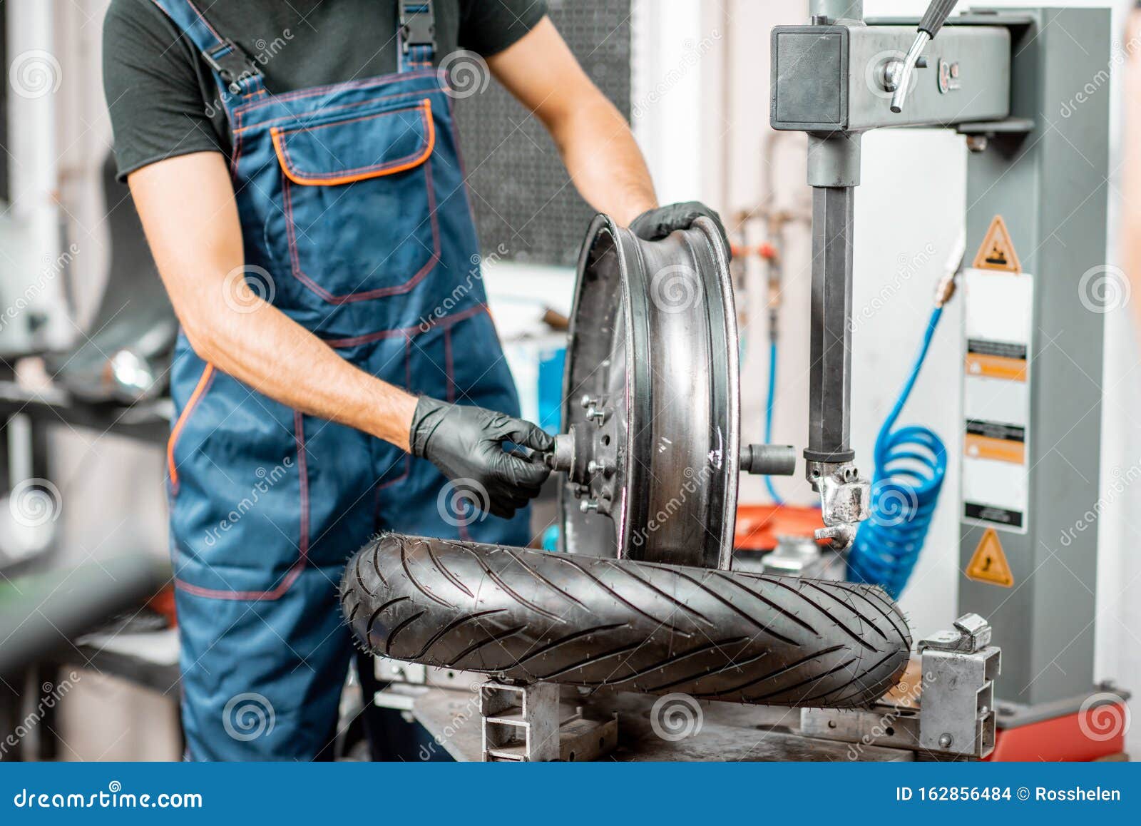 Worker Changing a Motorcycle Tire Stock Photo - Image of equipment