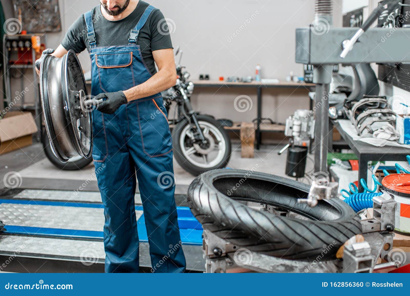Worker Changing a Motorcycle Tire Stock Photo Image of repairman