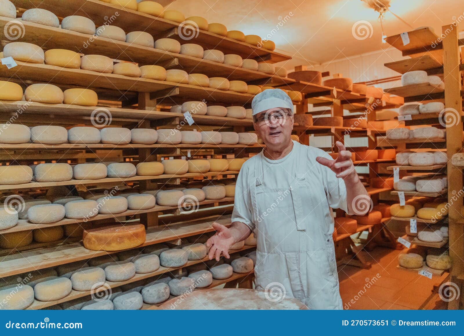A Worker at a Cheese Factory Sorting Freshly Processed Cheese on Drying