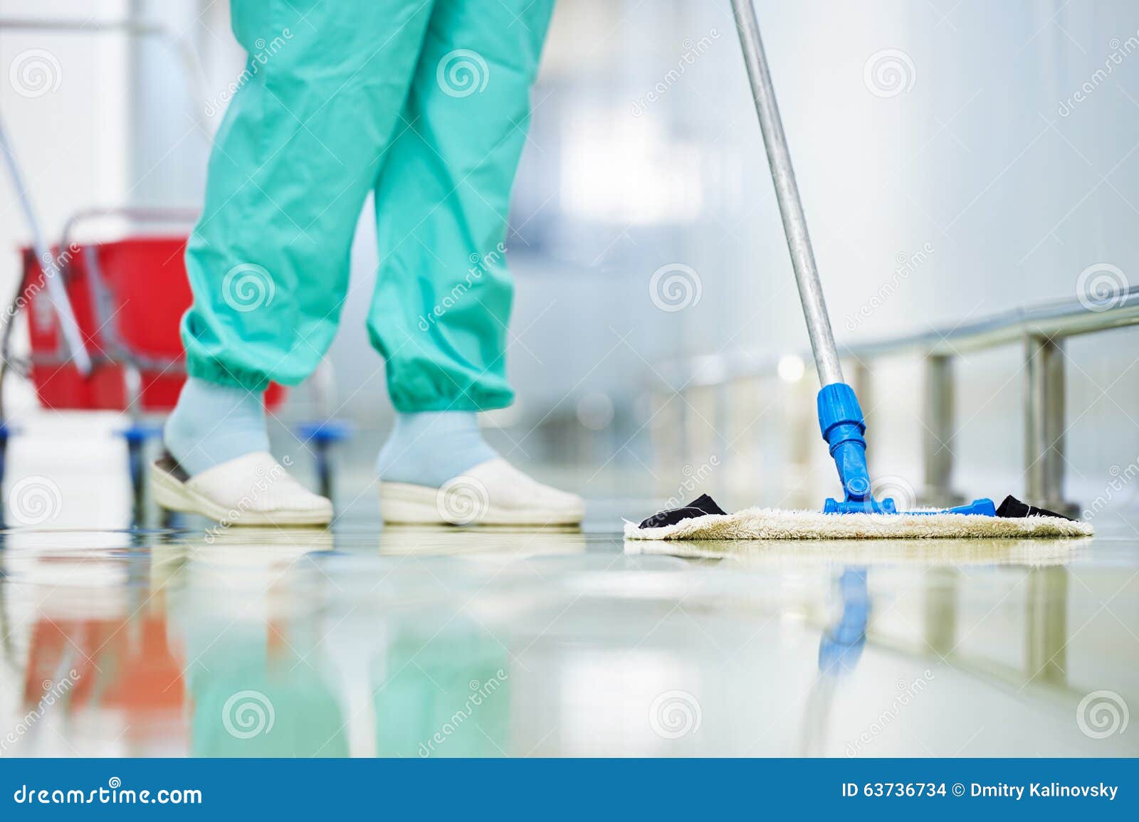 worker cleaning floor with mop
