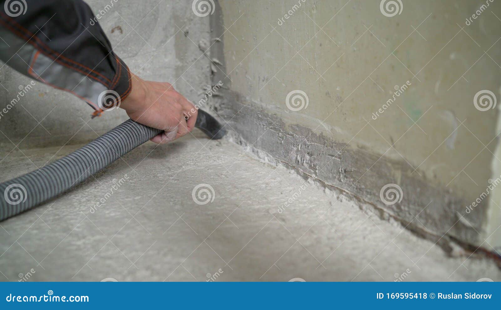 Worker Cleaning Floor With Vacuum Cleaner From Industrial Concrete Dust And Cement Dirt During How To Clean Up Concrete Dust
