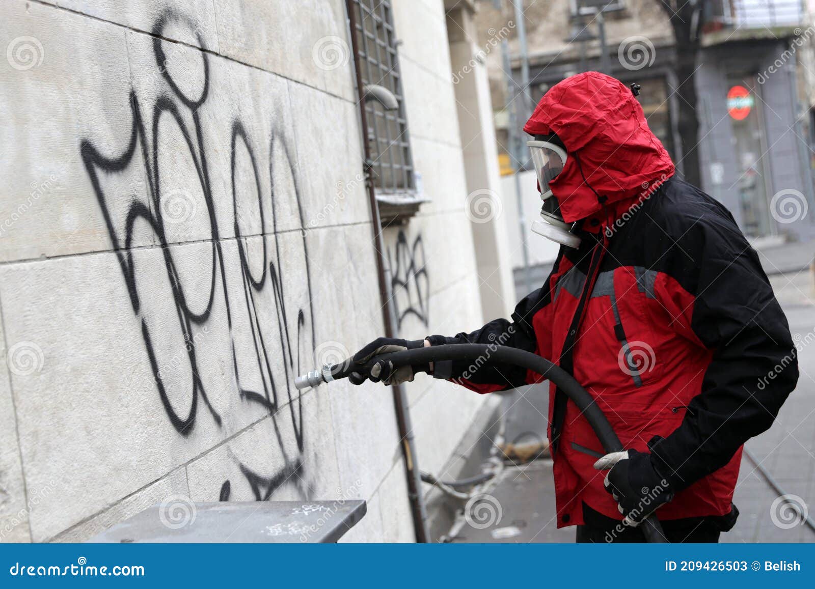 Worker cleaning graffiti editorial stock photo. Image of uniform