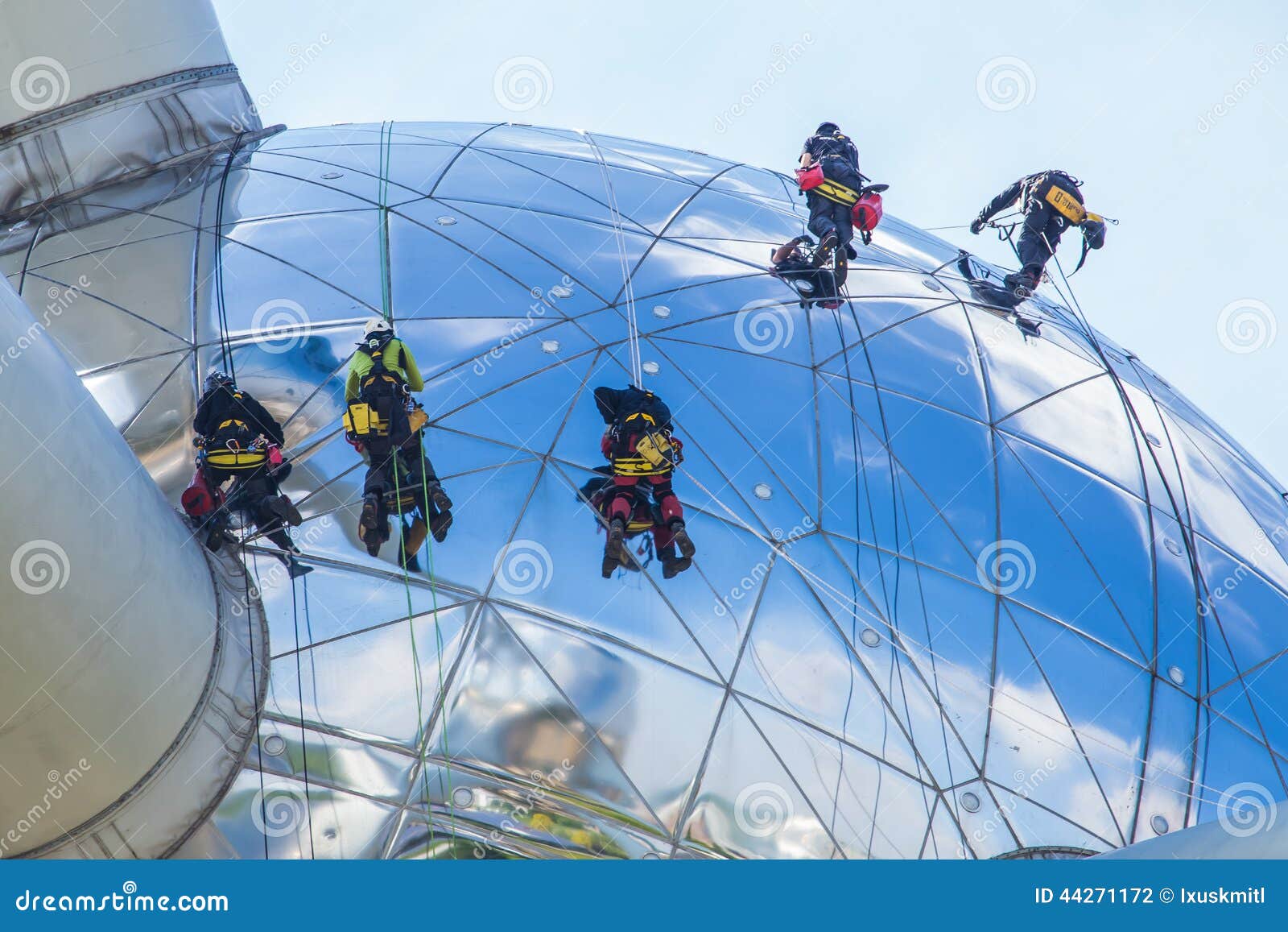 Worker cleaning high tower editorial photography. Image of mirror