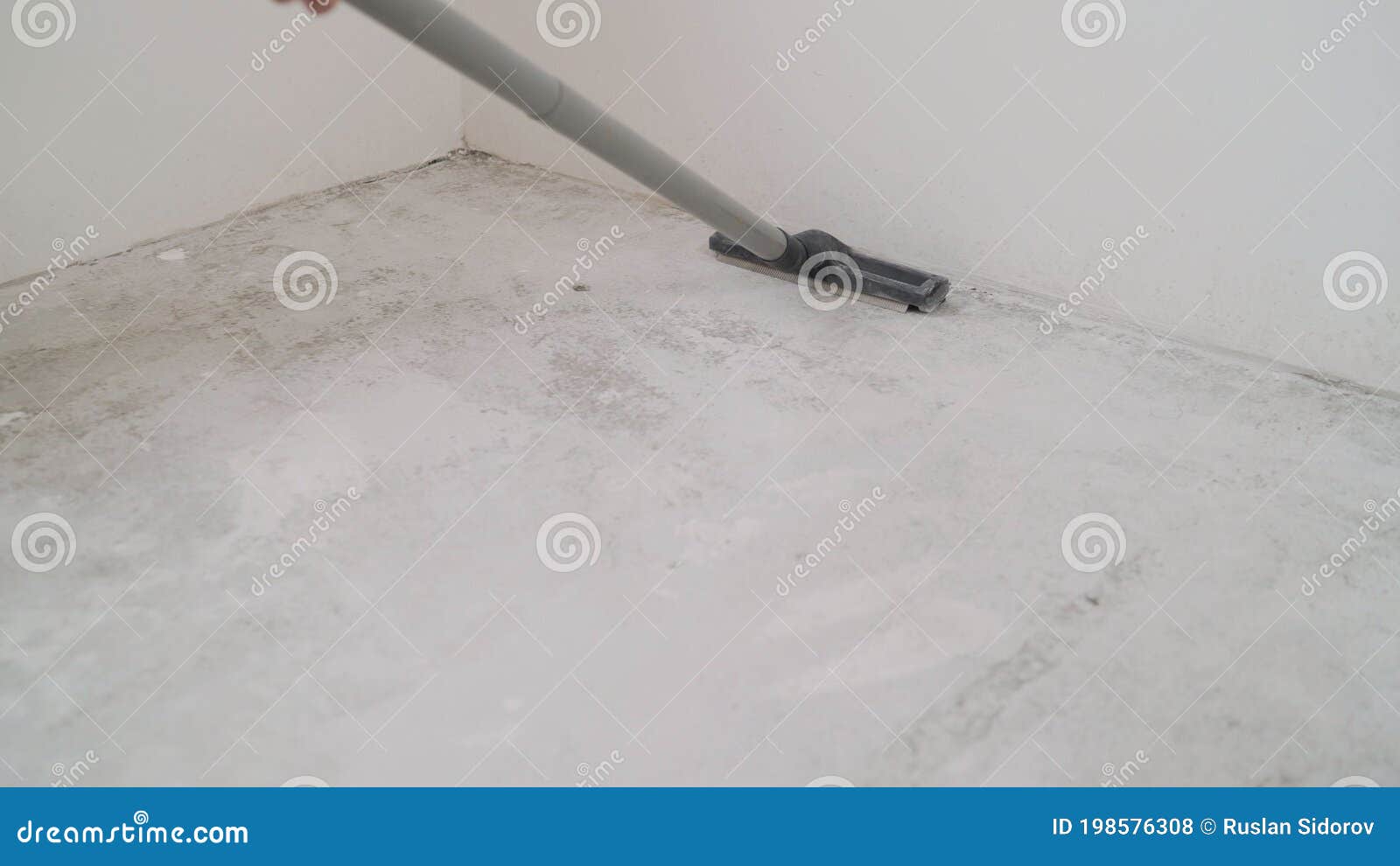 A Worker Is Cleaning The Concrete Floor With A Vacuum Cleaner. A Worker Is Cleaning A Public How To Clean Up Concrete Dust
