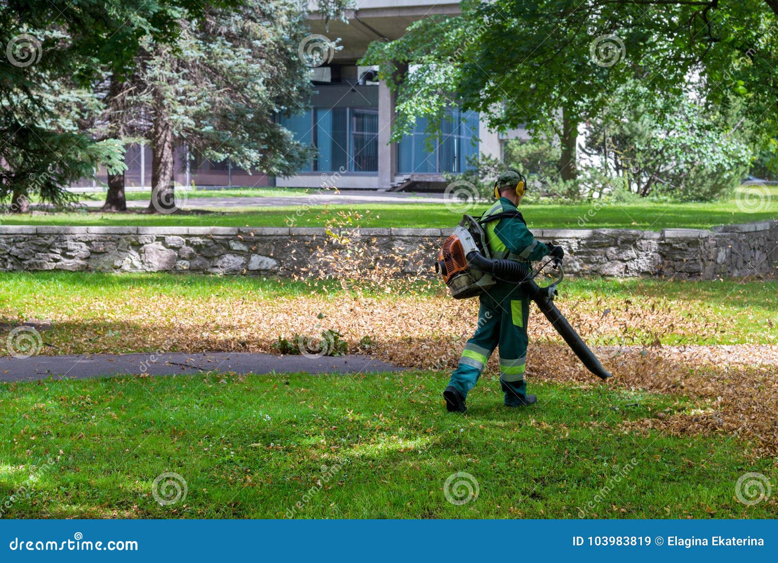 Worker is Cleaning Up in the City Park Using Leaf Blower Tool Editorial