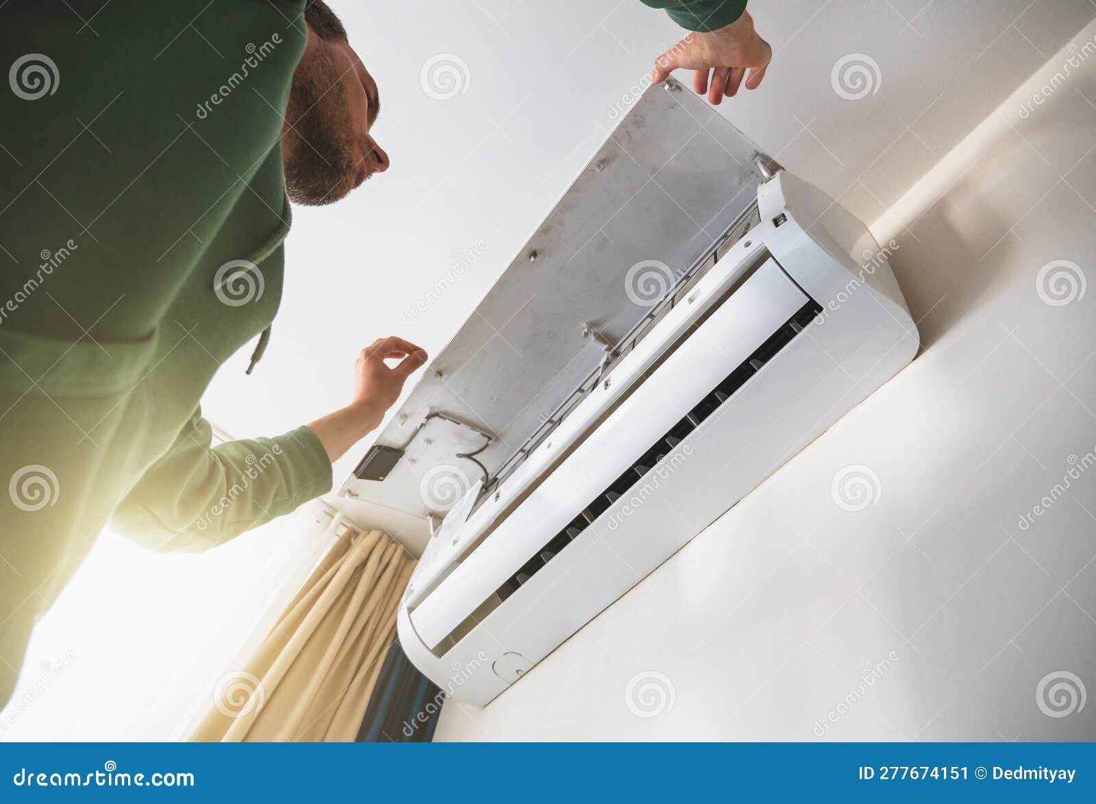 Worker Cleans Air Conditioner. Maintenance of Cooling Systems before