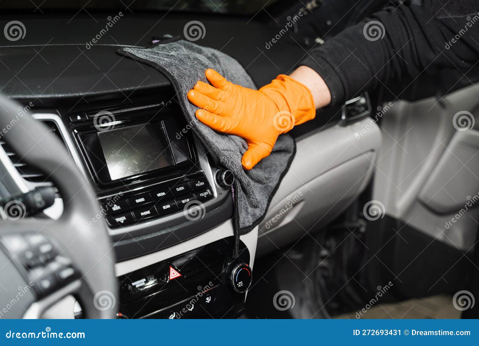 Worker Cleans Cars Using Microfiber Cloth To Dry the Dashboard during