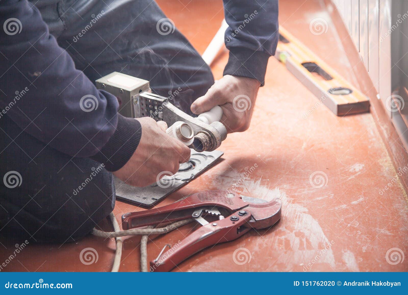 Worker Connecting Plastic Pipe. Installing Water Heating Radiator Stock