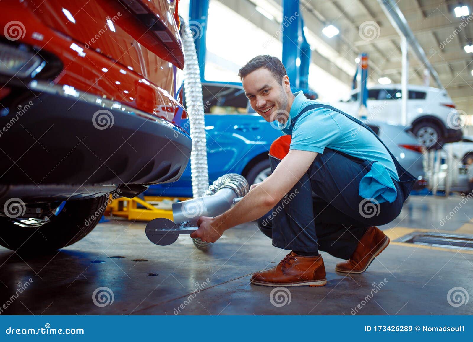 Worker Connects the Exhaust Gas Ventilation System Stock Image - Image