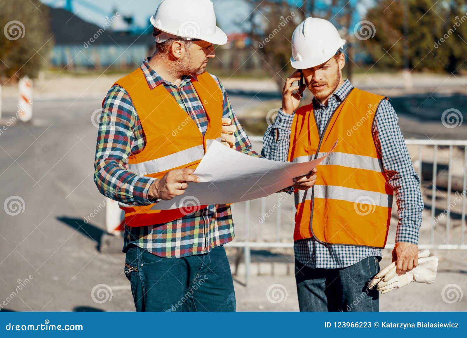worker and construction manager consulting on a project with eng