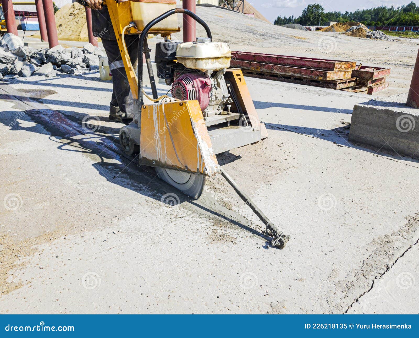 A Worker at a Construction Site Cuts Concrete with a Diamond Saw