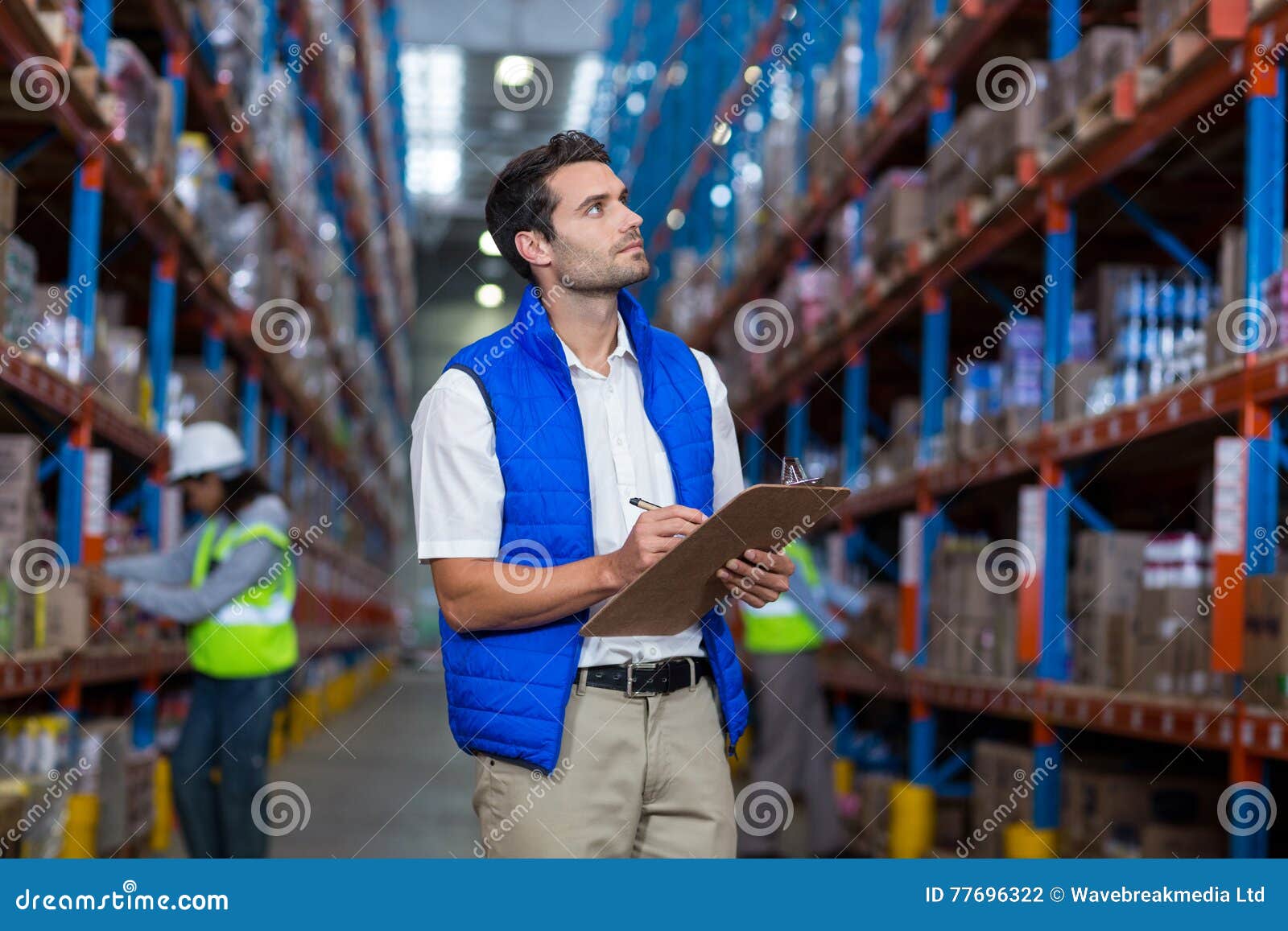 Worker controlling stocks stock photo. Image of helmet 77696322