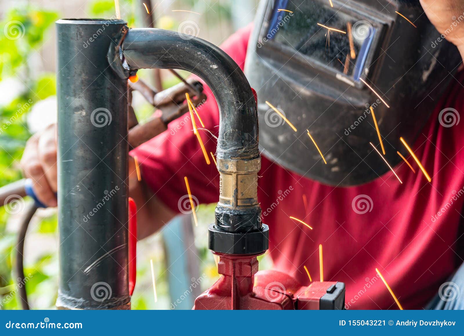Worker Cooks the Heating Pipe, Welding Joint. Preparing for Winter