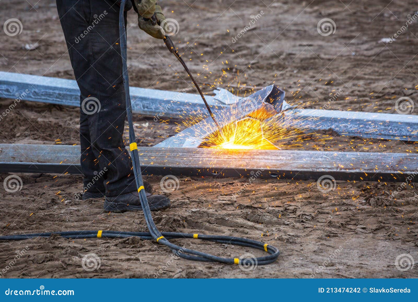 A Worker Cut Steel Beams Using Propane-oxygen Torch. Stock Photo