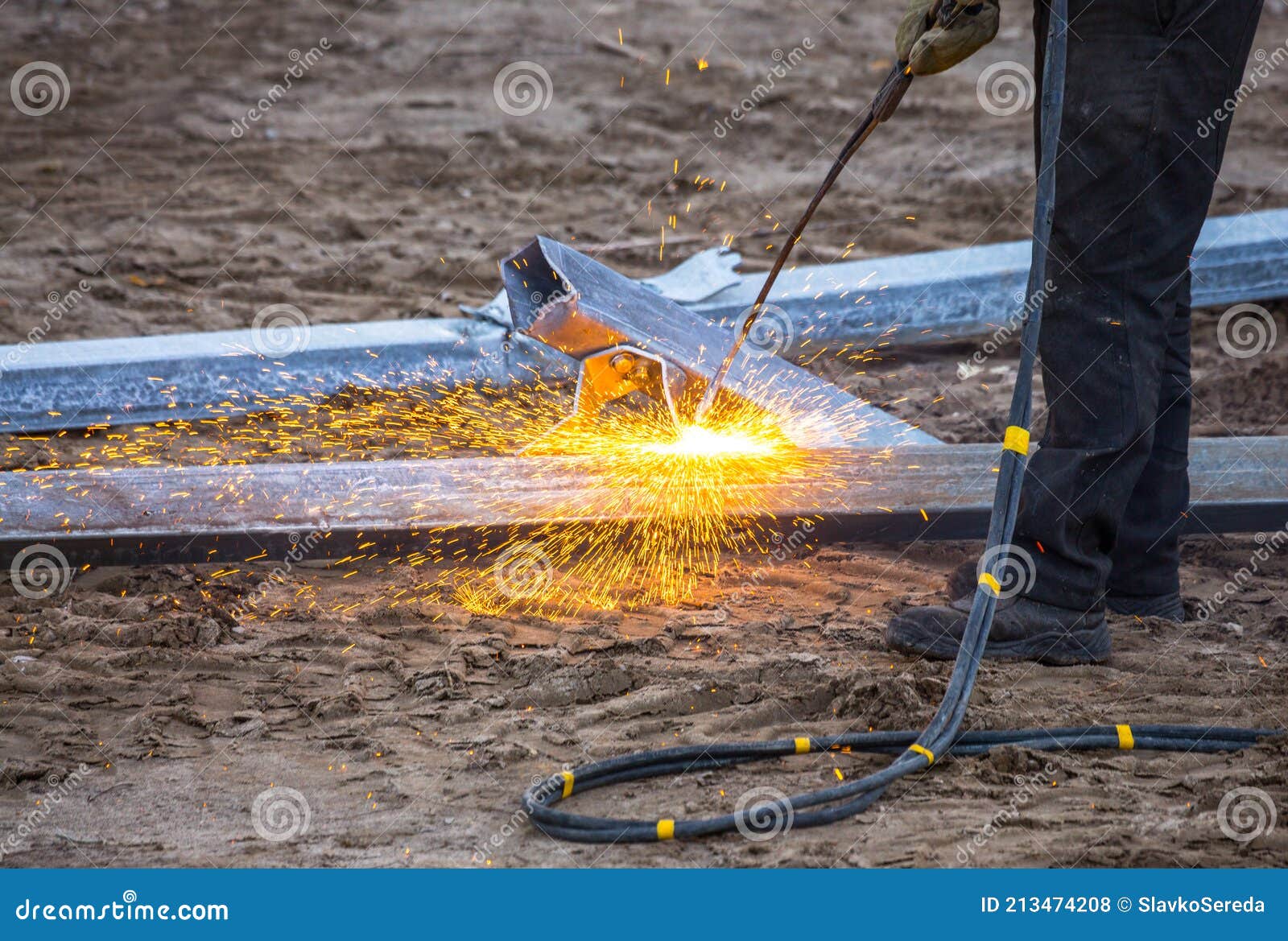 A Worker Cut Steel Beams Using Propane-oxygen Torch. Stock Photo