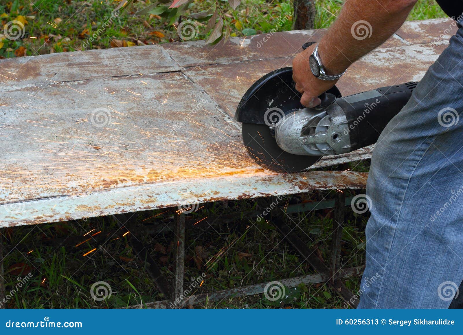 Worker Cuts Metal Sheet by Angle Grinder Stock Image Image of jeans