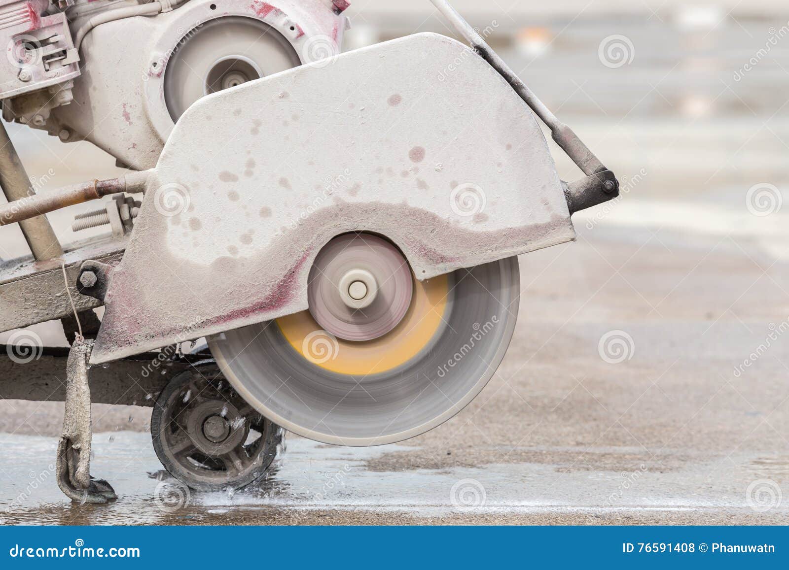 Worker Cutting Concrete Road with Diamond Saw Blade Machine Stock Photo