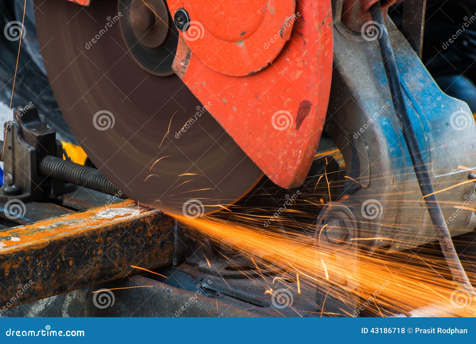 Worker Cutting Metal with Grinder. Sparks while Grinding Iron Stock