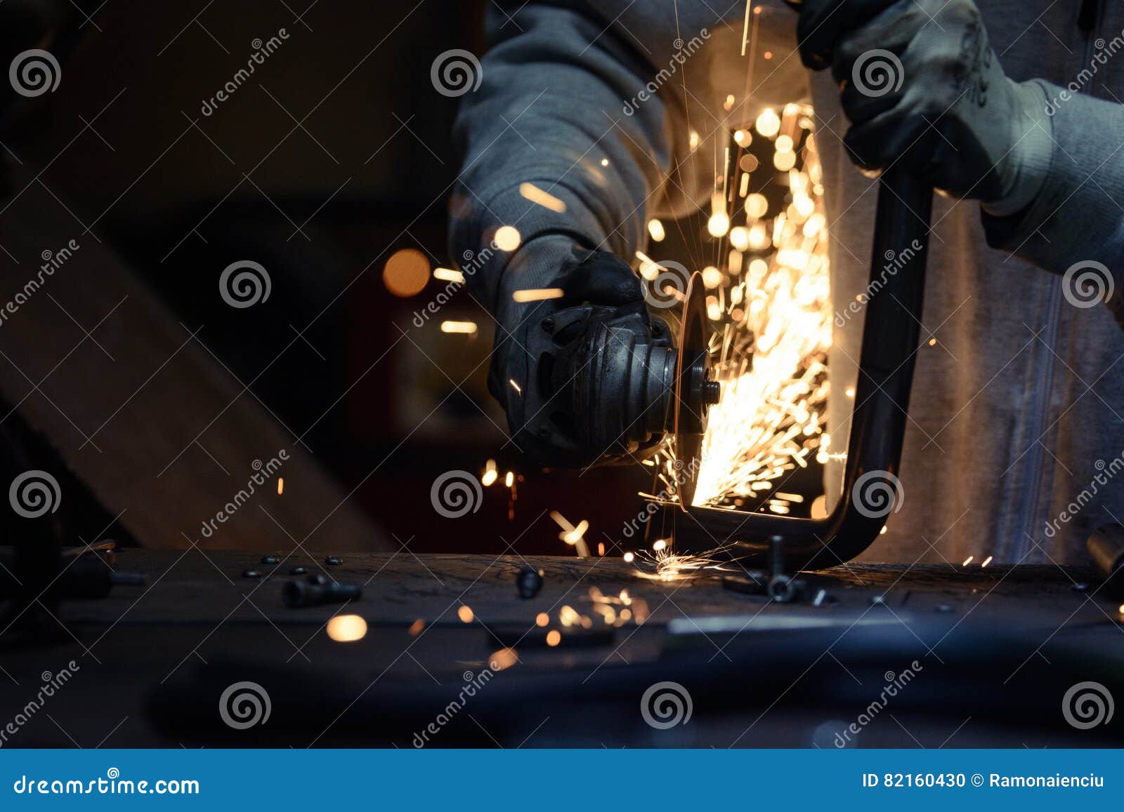 Worker Cutting Metal Pipe Using Angular Grinding Machine. Stock Photo