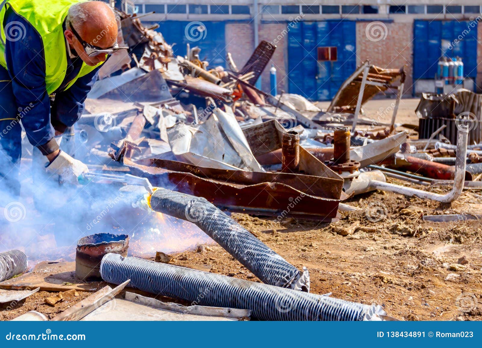 Worker is Cutting Scrap Metal with Acetylene Torch Editorial Photo