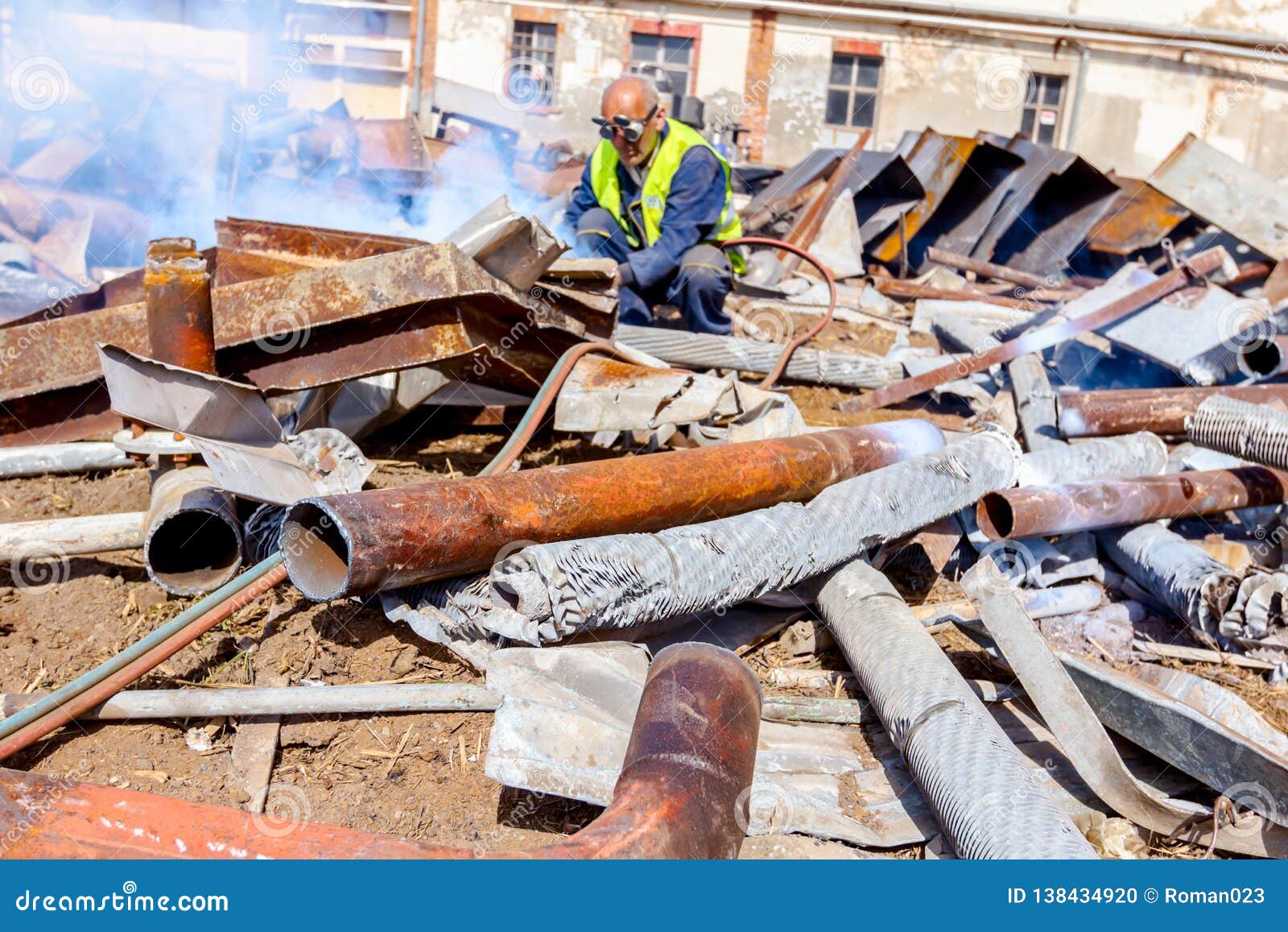 Worker is Cutting Scrap Metal with Acetylene Torch Editorial Image