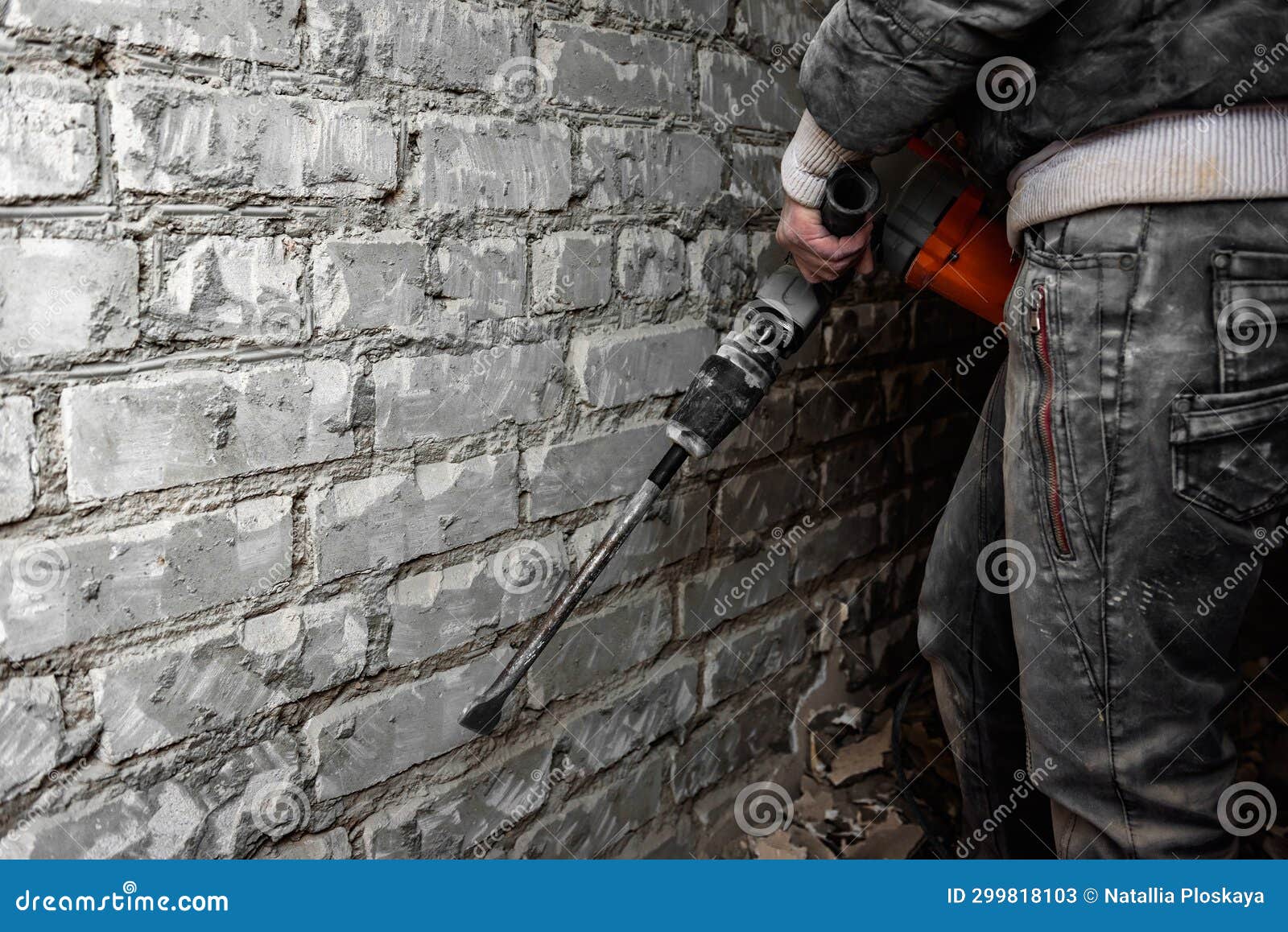 Worker with Demolition Hammer Removing Plaster from Wall. Stock Image