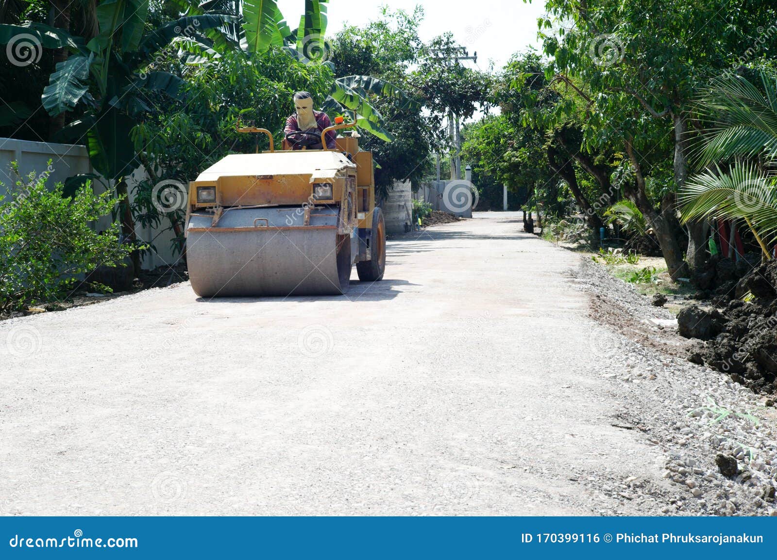Worker Drives the Road Roller on the Crash Stone Road for Preparaing
