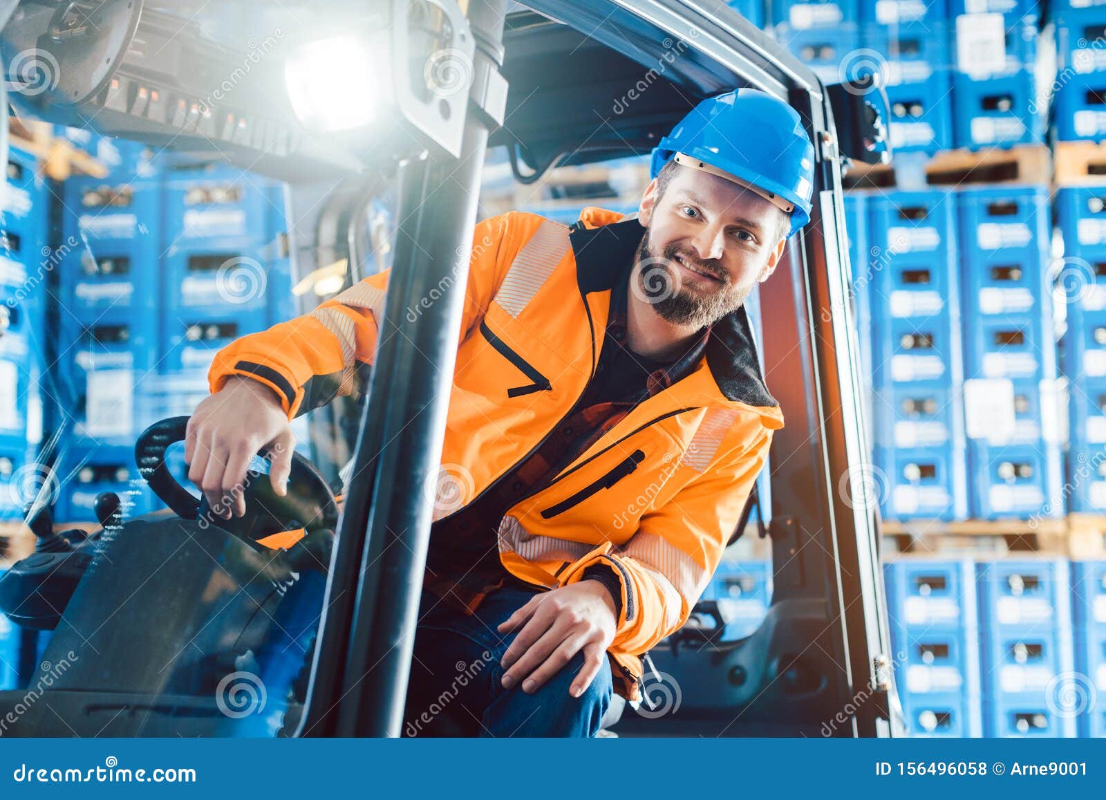 Worker Driving a Forklift in Logistics Delivery Center Stock Photo