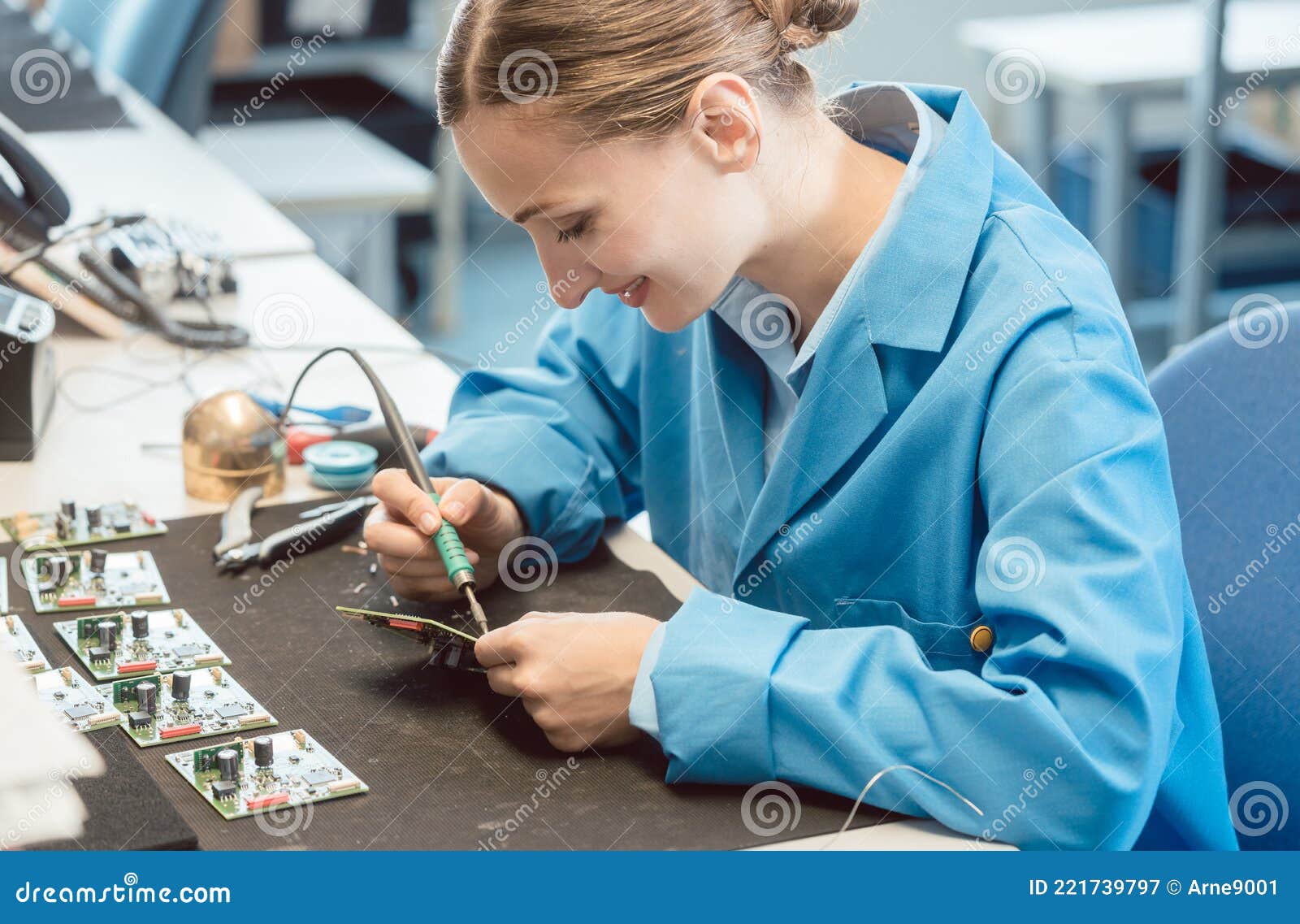 worker in electronics manufacturing soldering a component