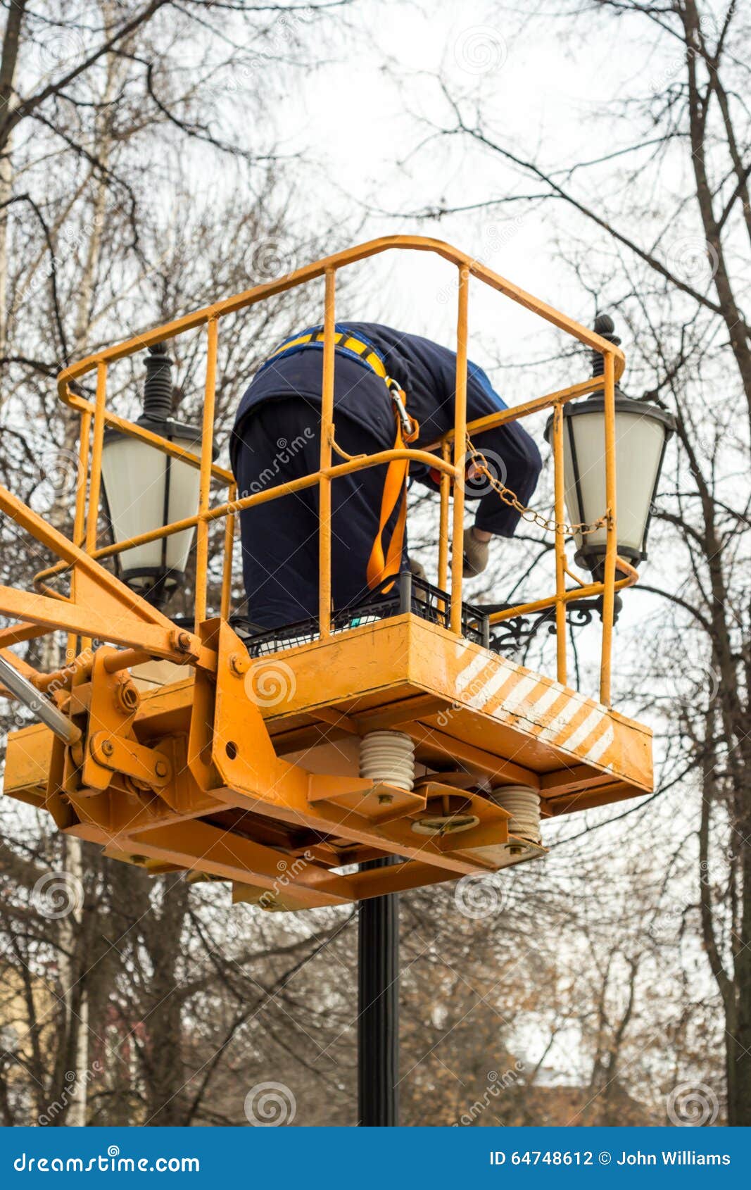 Worker Fixing a Ornamental Street Light Editorial Photography Image