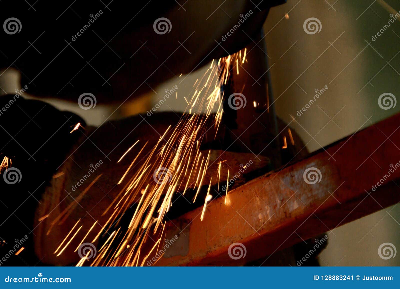Worker Grinding Cutting Metal Sheet with Grinder Machine and Sparks