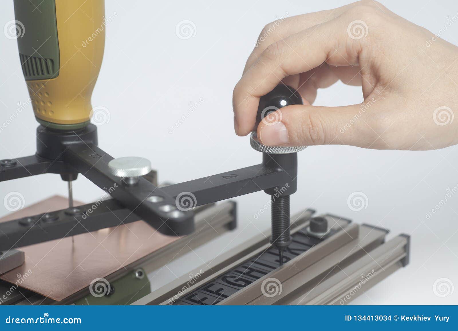 worker hands on engraving device pantograph with cnc engraver with letterpress alphabet