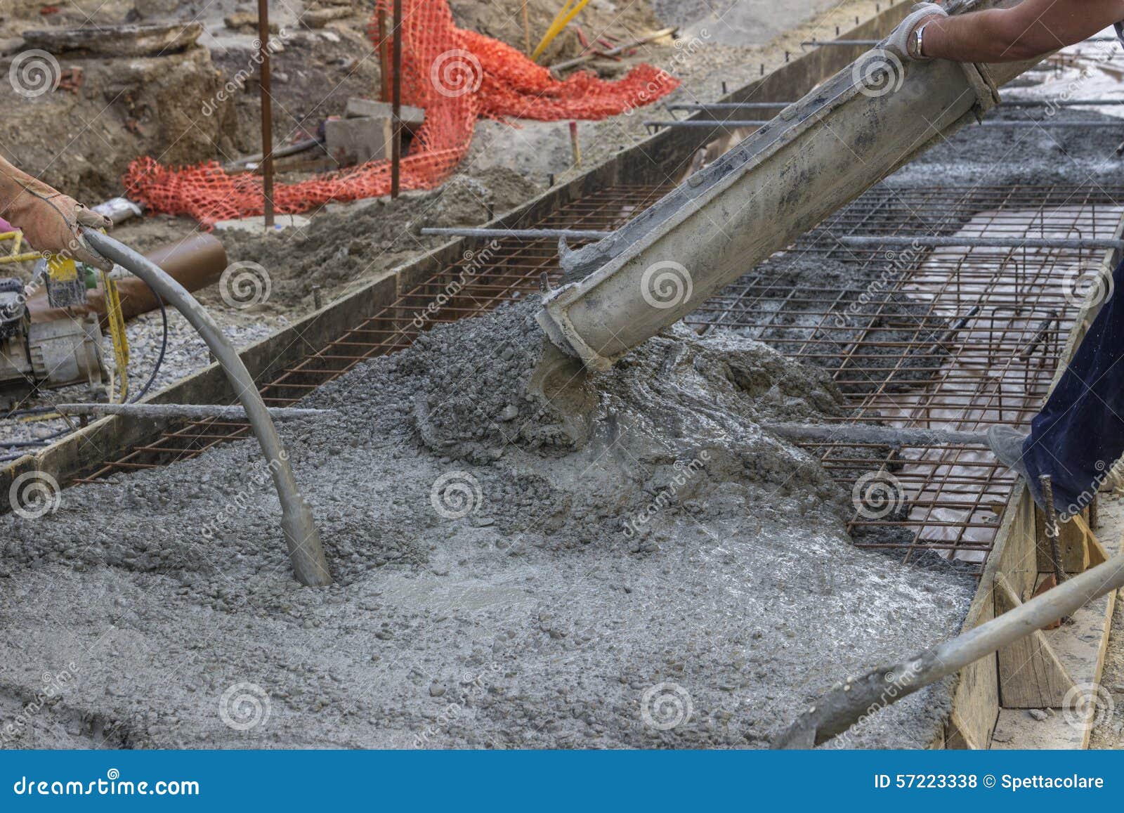 worker hands using concrete vibrator 2