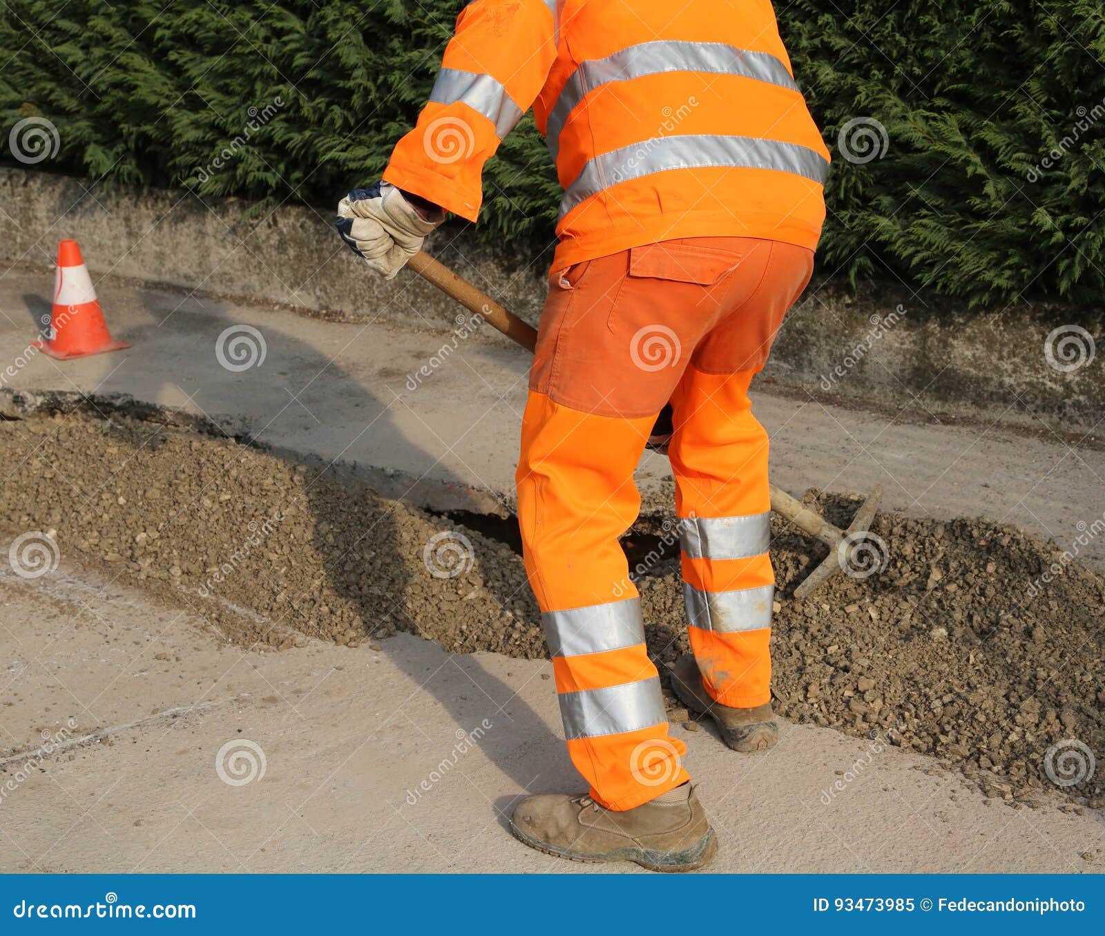 Worker with High Visibility Clothing while Working on a Road Con Stock