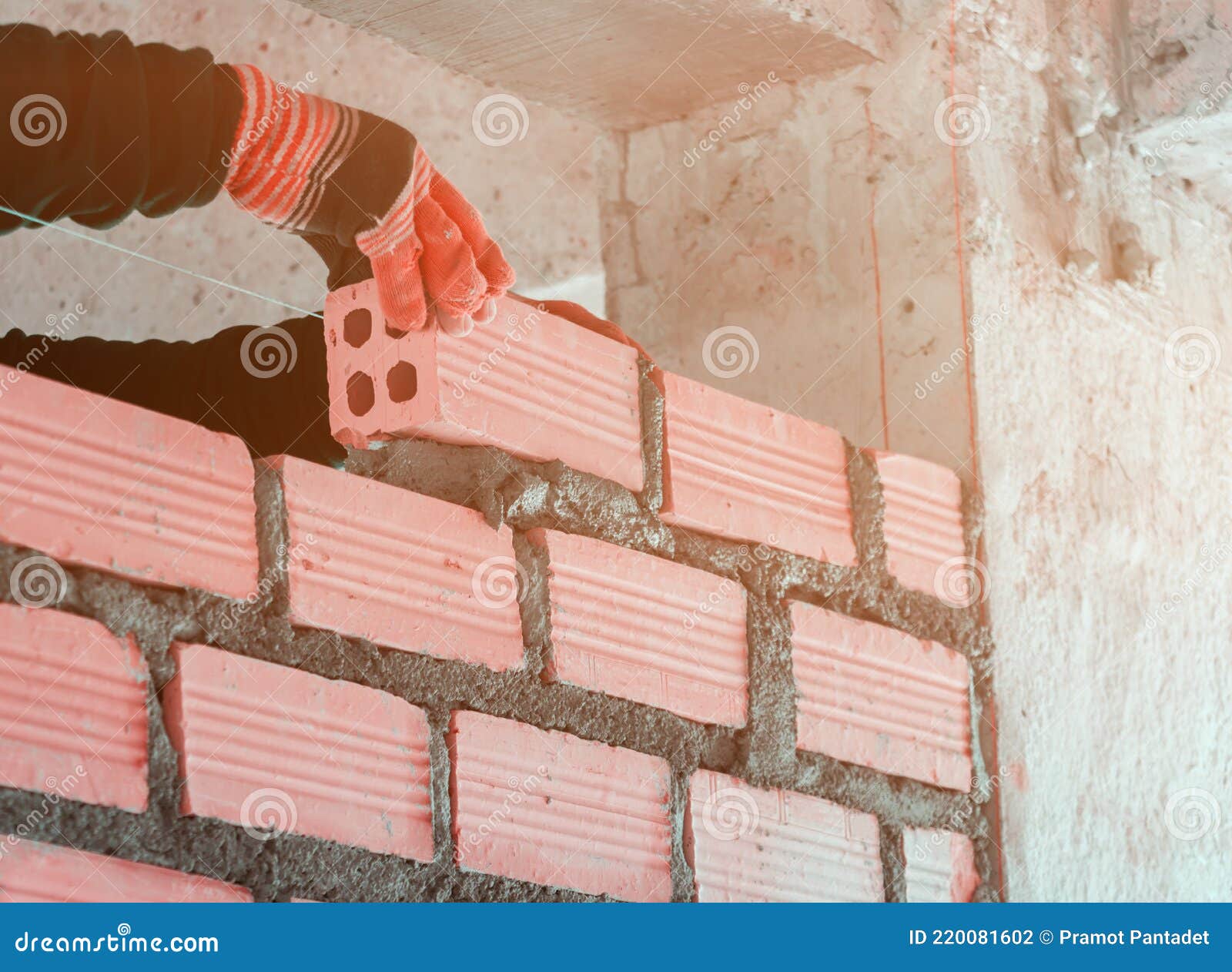 Worker Industrial Bricklayer Installing Laying Brick Inside and
