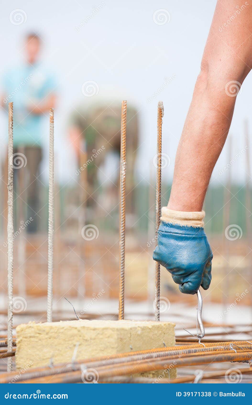 worker installing binding wires in formwork