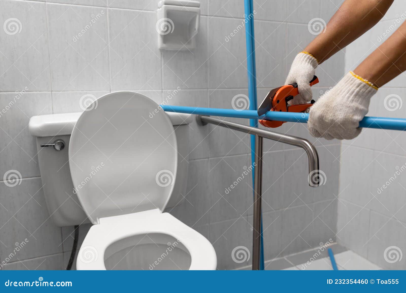 worker installing floating pipeline on the wall in the old bathroom