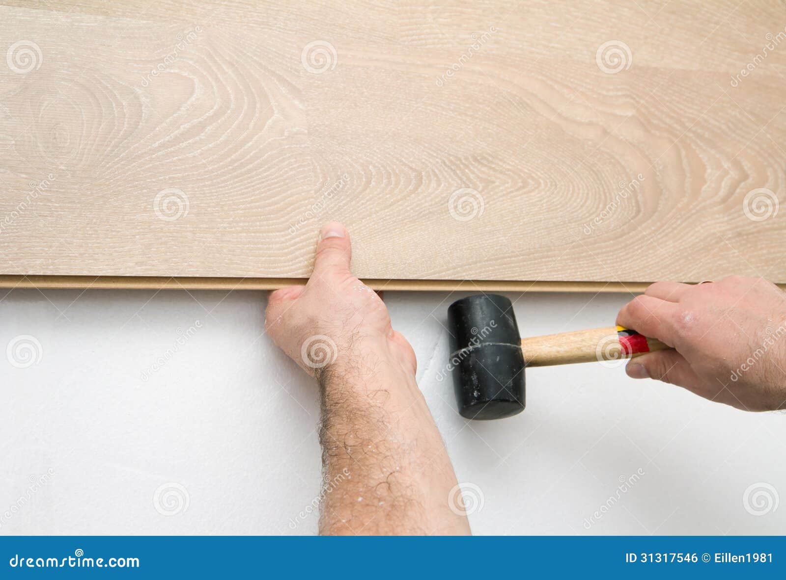 Worker Installing Laminate Floor Using a Hammer Stock Photo Image of