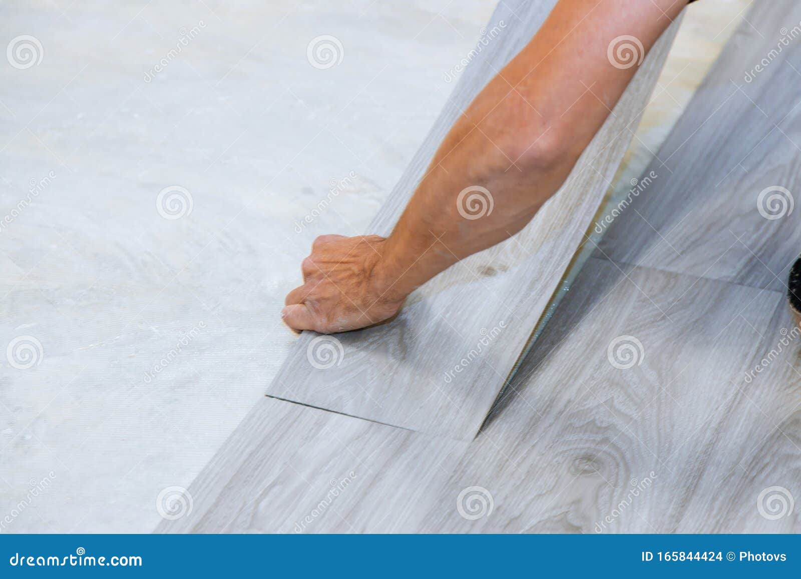 Worker Installing New Vinyl Tile Floor Laminate Wood Texture Floor