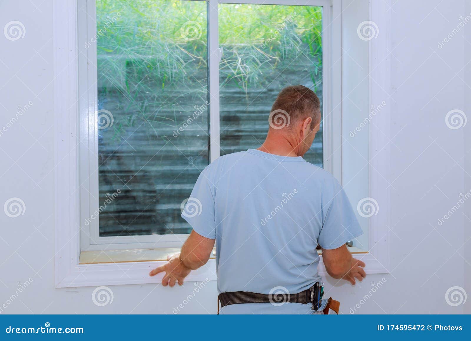 Worker Installing Trim Around a Window Stock Photo Image of structure, moldings 174595472