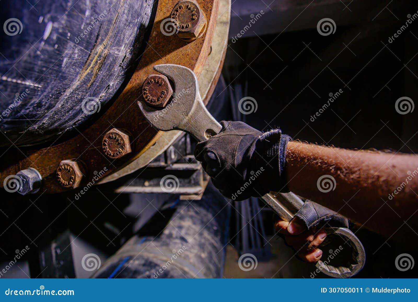 Worker Installing Water Pipeline System in Technical Tunnel, Close Up