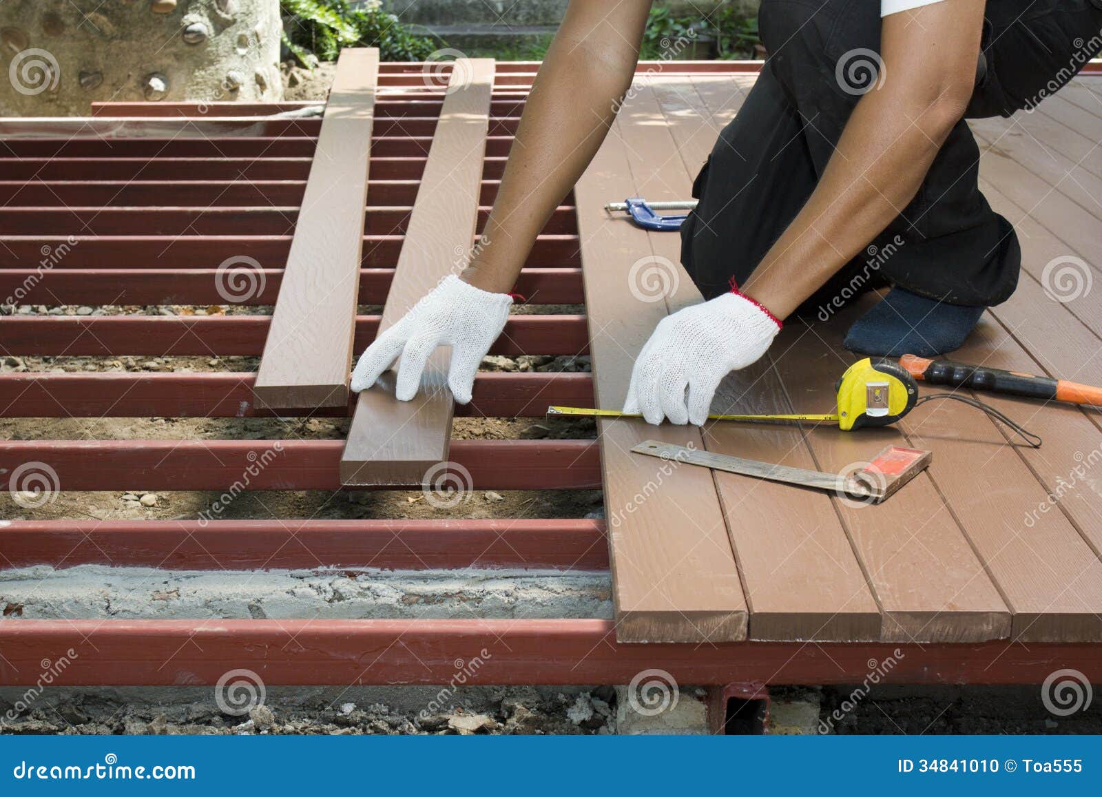 Worker Installing Wood Floor For Patio Stock Photo - Image: 34841010