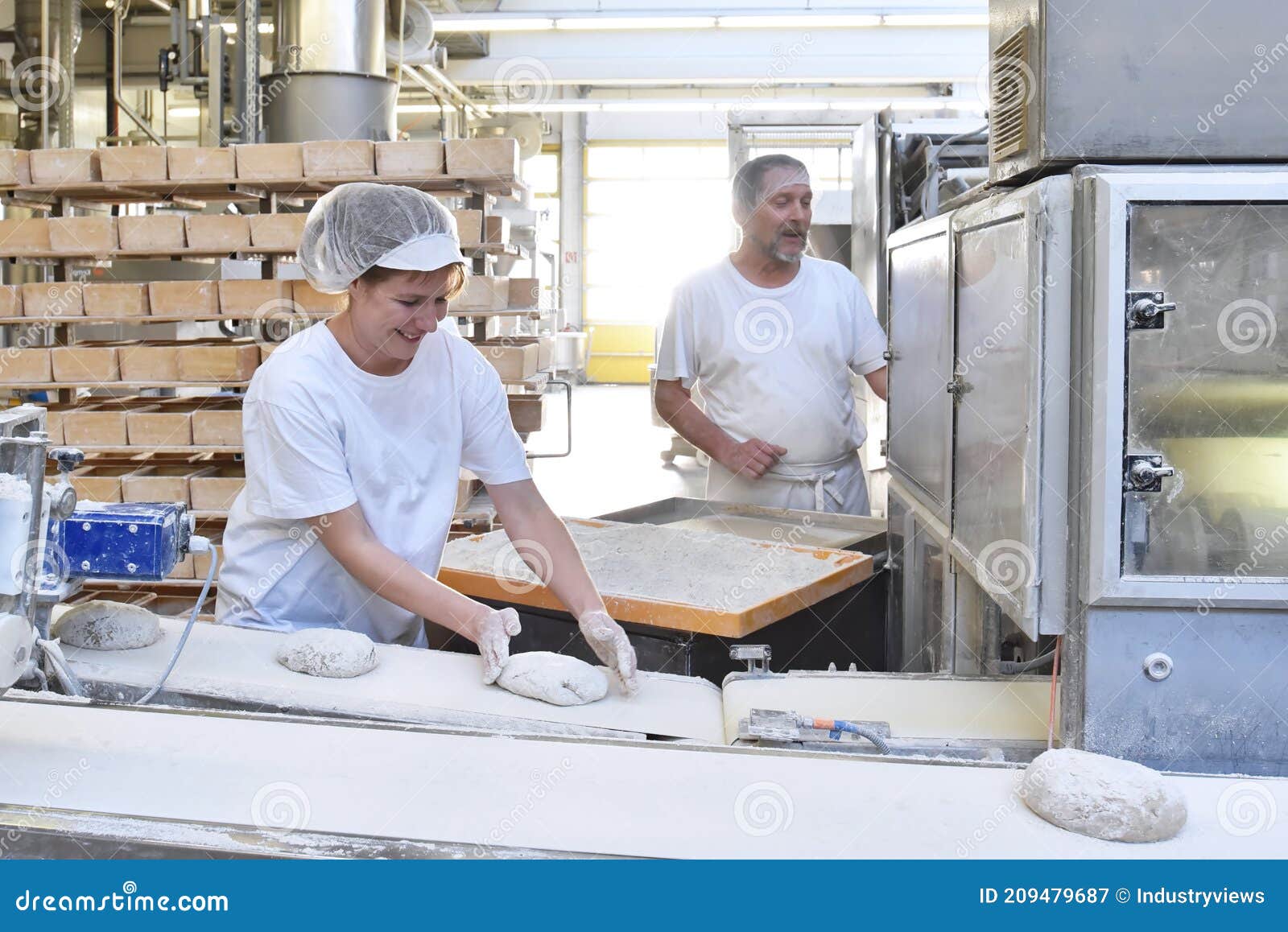 Worker in a Large Bakery Industrial Production of Bakery Products on