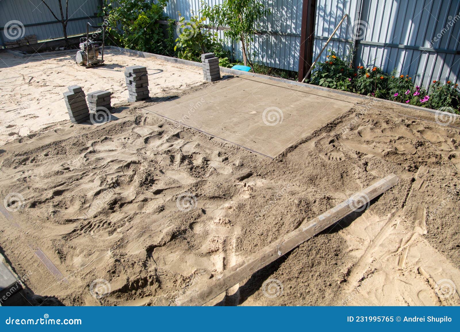 A Worker Lays Down Sand for Paving Slabs. Stock Image Image of
