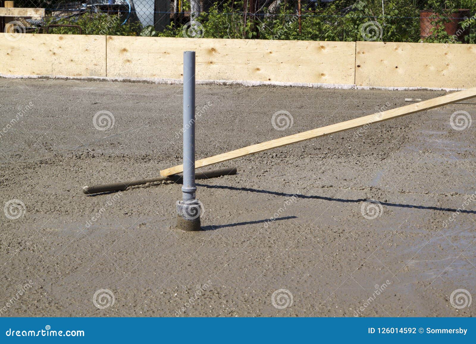 Worker Leveling Fresh Concrete Slab with Special Working Tool Stock