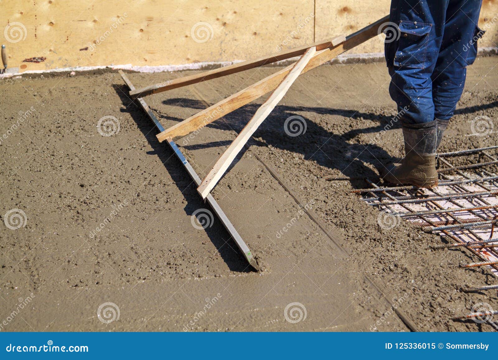 Worker Leveling Fresh Concrete Slab With Special Working Tool