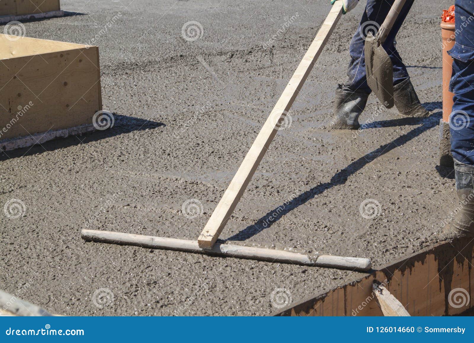 Worker Leveling Fresh Concrete Slab with Special Working Tool Stock