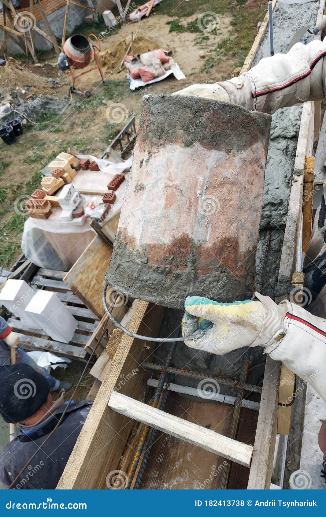 Worker Lines Concrete in Formwork with Trowel, Construction of New Home