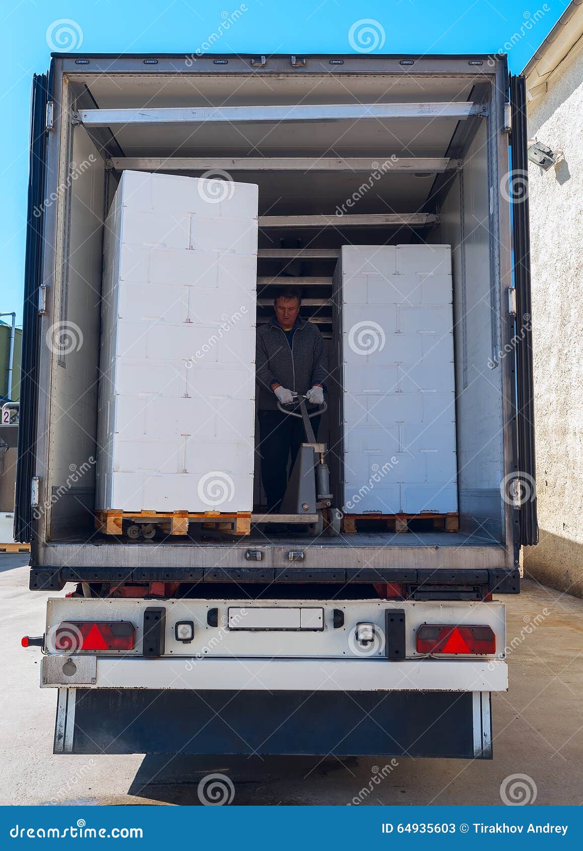 Worker loads semitruck stock image. Image of loading 64935603